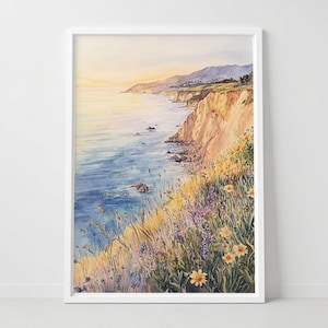 May include: Watercolor painting of a coastal landscape with a cliffside, ocean, and sky. The artwork features a vibrant color palette of blues, yellows, and greens, with wildflowers in the foreground. The painting is framed in a white border.