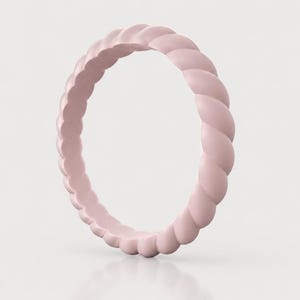 May include: A pale pink ring featuring a continuous twisted rope texture around the entire band. The ring has a smooth, matte finish and a uniform circular shape, showcasing a simple design with a consistent light pink color throughout the piece.