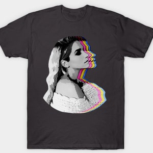 May include: A black and white graphic t-shirt design featuring a woman's face with a layered, colorful effect. The woman is looking to the right and has long blonde hair. She is wearing a white crocheted top.