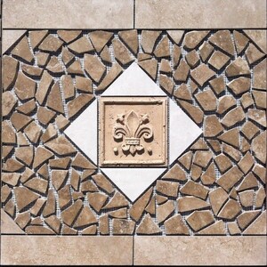 May include: A decorative tile with a brown and white mosaic pattern. The center of the tile features a white diamond with a brown square inside. The square has a raised design of a fleur-de-lis.