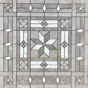May include: A gray and white geometric tile pattern with a starburst design in the center. The tile is made of marble and has a polished finish.