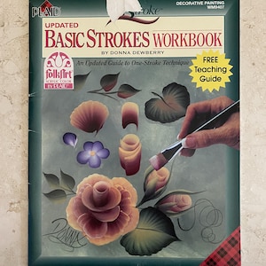 Op de afbeelding: Een instructiewerkboek getiteld "Updated Basic Strokes Workbook" van Donna Dewberry. De omslag toont een geschilderd bloemendesign en een hand die een penseel vasthoudt. Het boek is voor decoratief schilderen en bevat een gratis lesgids.