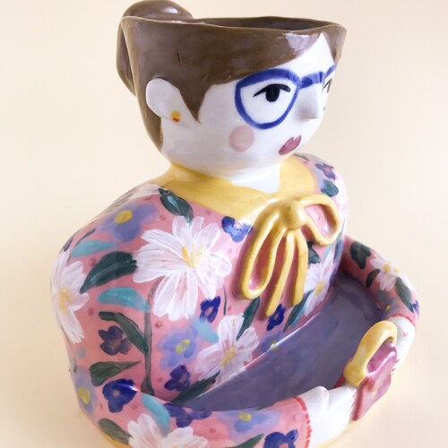 Pink shops and yellow woman planter pot