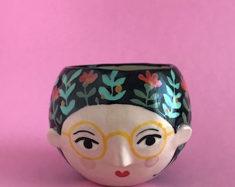 small ceramic woman's face vase made and decorated by hand