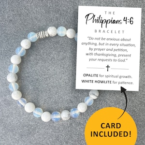 May include: White and blue gemstone bracelet with a silver charm. The bracelet is accompanied by a card with the text "THE Philippians 4:6 BRACELET "Do not be anxious about anything, but in every situation, by prayer and petition, with thanksgiving, present your requests to God." t OPALITE for spiritual growth. WHITE HOWLITE for patience. CARD INCLUDED!"