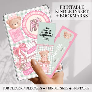 May include: A clear Kindle case with a pink and green gingham pattern, featuring teddy bear and bow illustrations. Includes printable bookmarks with text: "a reader lives a thousand lives" and "Lovers Club". The text "PRINTABLE KINDLE INSERT + BOOKMARKS" is also visible.