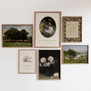 May include: A selection of framed art prints displayed on a white wall. The prints feature landscapes, portraits, and floral still lifes. The frames are a light brown colour. Some prints include text. The overall aesthetic is vintage.
