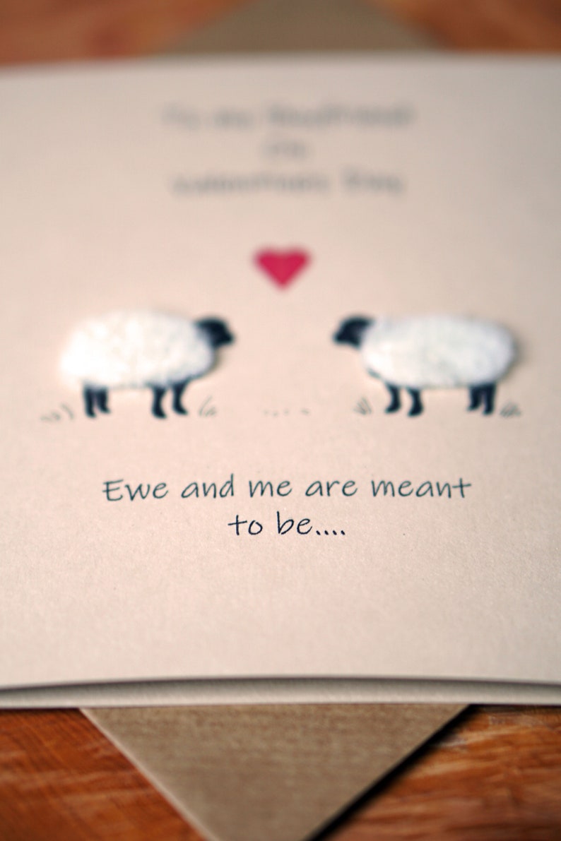 May include: A card with two white sheep facing each other with a red heart above them. The card says "Ewe and me are meant to be..."