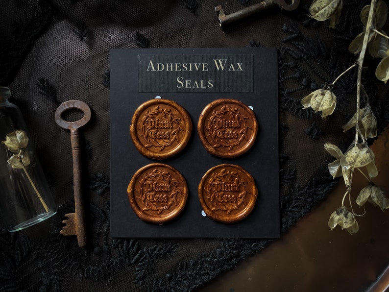 May include: Four gold adhesive wax seals with the text "Thank You" in a decorative font. The seals are displayed on a black card with the text "Adhesive Wax Seals".