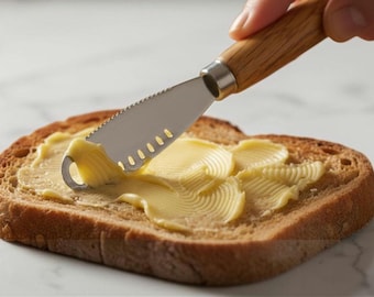 Butter spreader knife, stainless steel, serrated edge, curling holes, oak whisky barrel handle