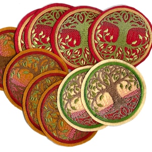 May include: A collection of round embroidered patches featuring a tree design. The patches have a variety of colors, including red, green, brown, and gold. The tree design is detailed with leaves and branches. The patches are likely for decorative purposes.