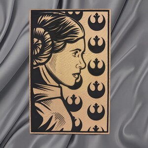 May include: A wooden plaque featuring a black and tan portrait of a woman in profile, with a hairstyle and attire reminiscent of a science fiction character. The background includes repeating black symbols. The plaque is set against a gray fabric.