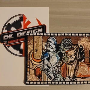 May include: Embroidered patch featuring two Star Wars characters, a blue and white Stormtrooper and a green and brown Yoda, standing side-by-side against a brown and white background. The patch has a black border with a white film strip design.