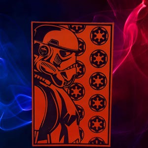 May include: Orange rectangular graphic featuring a black silhouette of a Star Wars Stormtrooper helmet and the Galactic Empire symbol. The background is a gradient of blue and red.