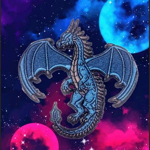 以下が含まれることがあります： 銀河と2つの惑星を背景に、翼を広げた青いドラゴン。ドラゴンは銀色の輪郭で、立っている。