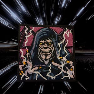 May include: Embroidered patch depicting a hooded figure with yellow eyes and a sinister grin. The patch shows the character with outstretched hands, emitting white lightning bolts. The background is a black and white space-themed design.