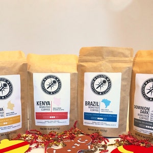 May include: Four brown paper bags of coffee beans from the Guide Roasting Company. The bags are labeled with the origin of the beans: Colombia, Kenya, Brazil, and Dominion Dark Roasted Coffee. Each bag has a net weight of 4 ounces (113 grams).