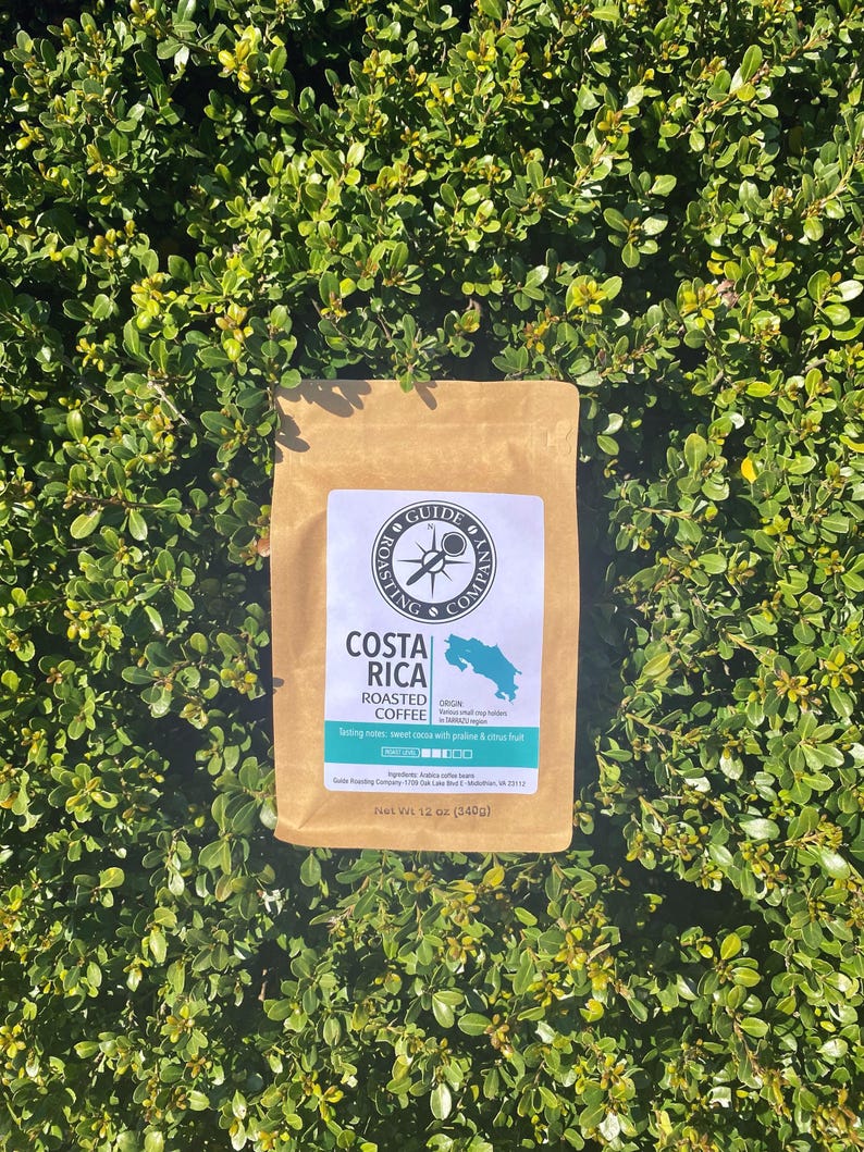 May include: A brown paper bag with a label that says "Costa Rica Roasted Coffee". The label also includes the origin of the coffee beans, which is "Tarrazu,  small coffee farms in San Jose, Costa Rica". The label also says "Tasting notes: sweet cocoa with prune & citrus fruit". The bag is 12 ounces (340g).