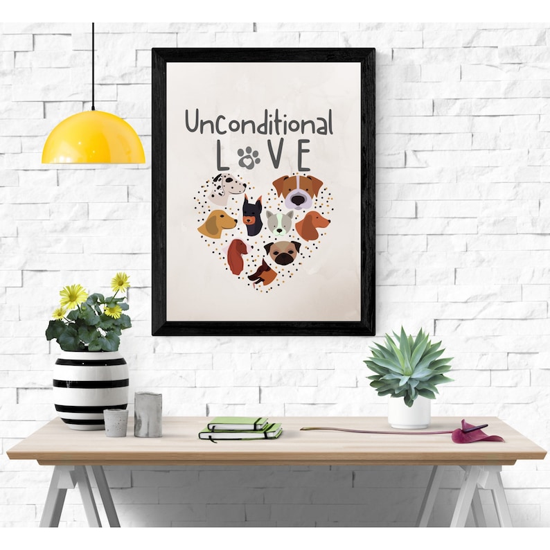 May include: A black framed print with a white background and the text "Unconditional LOVE" with a paw print between the "L" and "V". The print features a heart shape made of dog faces.