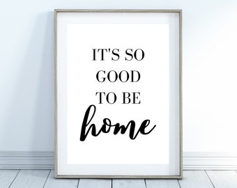 May include: A black and white printable wall art print with the text "It's so good to be home".