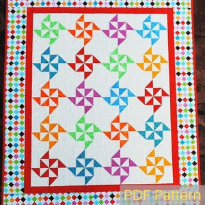May include: A colorful quilt pattern with a white background and a red border. The pattern features a series of colorful pinwheels in a repeating pattern. The quilt is labeled "PDF Pattern" in the bottom right corner.