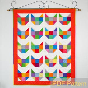 May include: A colourful quilt featuring a pattern of 20 cat faces made from patchwork squares. The quilt is framed with a red border and has a white background. The text "PDF Pattern" is visible in the bottom right corner.