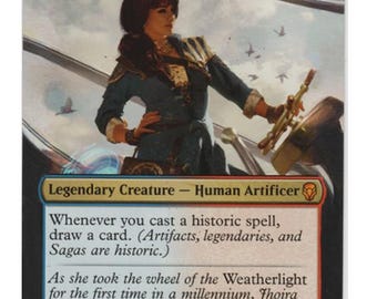 May include: A Jhoira, Weatherlight Captain trading card featuring a human artificer at a ship's wheel. The card text includes the name, mana cost, creature type, ability text, flavor text, and a 3/3 power and toughness rating in the bottom corner.