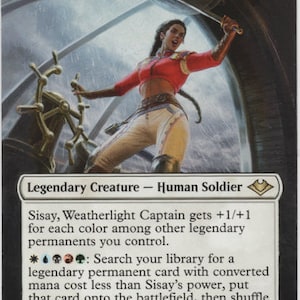 May include: A white card with black text and a colorful illustration of a woman holding a sword. The text reads "Sisay, Weatherlight Captain" and "Legendary Creature - Human Soldier". The card has a mana cost of 2 and a power and toughness of 2/2.