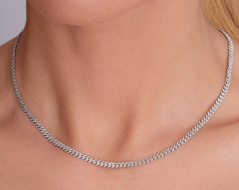 May include: A silver chain necklace with a delicate, slightly curved link design.