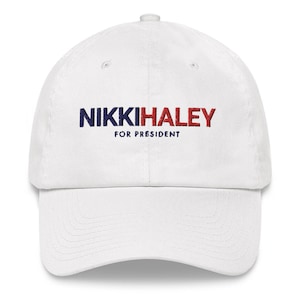 May include: White baseball cap with the text "NIKKI HALEY FOR PRESIDENT" embroidered in red and blue.
