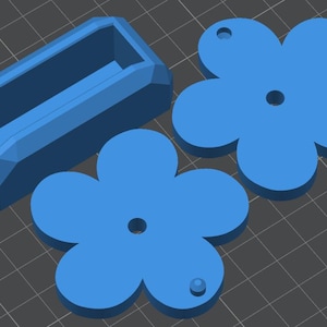 May include: Three blue plastic shapes: a rectangular box with a hollow interior, and two six-pointed star shapes with a hole in the center.