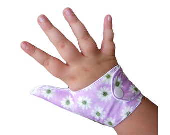 Thumb guard in a Daisy themed fabric on a lavender background, help children stop thumb sucking. May be pulled off by babies and toddlers.