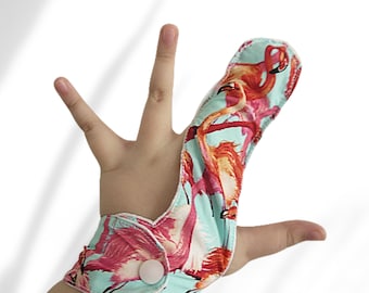 Fabric finger guard,  flamingo theme. Helps stop finger sucking. May be pulled off by babies.