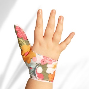 Thumb guards  thumb sucking stops thumb gloves  flower themed fabric. May be pulled off by babies and toddlers.