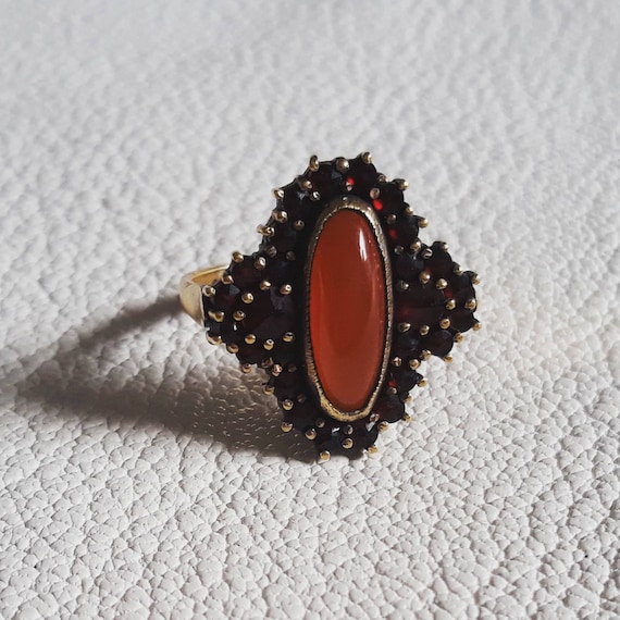 Vintage ring with grenades and horns. Vintage gild