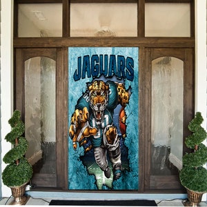 May include: A door cover featuring a fierce jaguar in a teal and black football uniform, with the word "JAGUARS" in bold blue letters. The design has a distressed, cracked background, giving it a dynamic, action-oriented look.