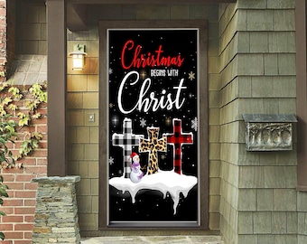May include: A Christmas-themed door banner with the text "Christmas begins with Christ." The banner features three crosses with different patterns: black and white plaid, leopard print, and red plaid. A snowman is also present.