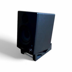 May include: Black studio monitor speaker with a single woofer and a tweeter. The speaker is on a black stand with a silver metal bar.