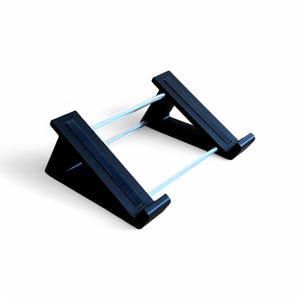 May include: A black tablet stand with a rectangular base and angled support arms. Two silver metal bars connect the support arms, providing stability. The stand is designed to hold a tablet or similar device.