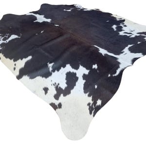 Medium Sized dark brown and white Genuine Cowhide Rug, Hair on Hide, Sold as Seen