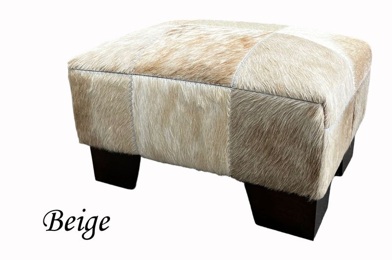 May include: Beige patchwork ottoman with four dark brown wooden legs.