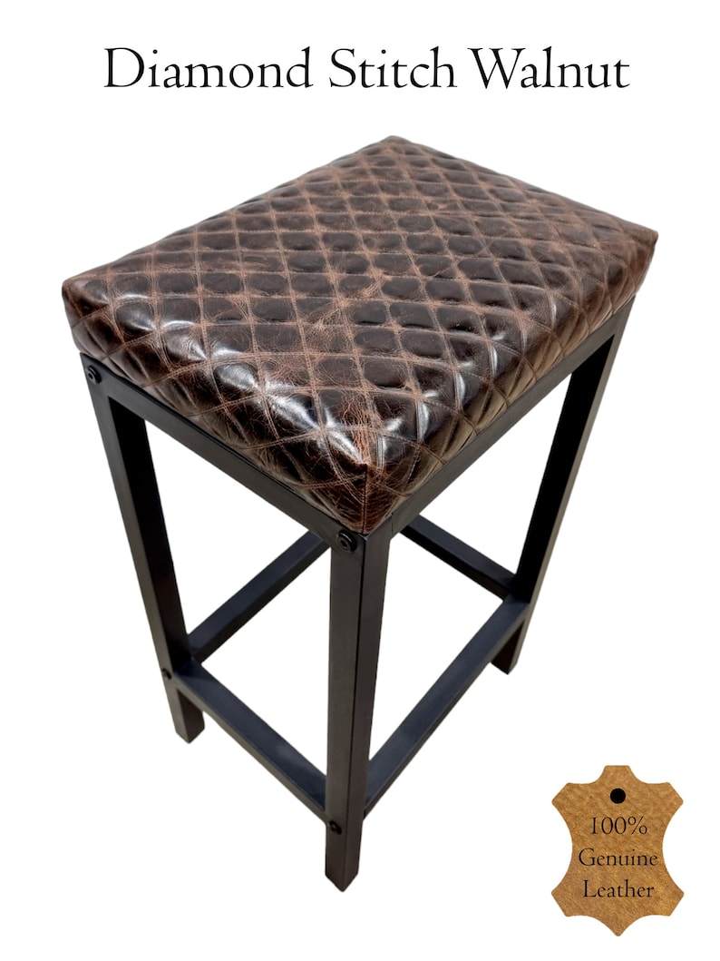 May include: A brown leather bar stool with a diamond stitch pattern. The stool has a black metal frame and a 100% genuine leather seat.