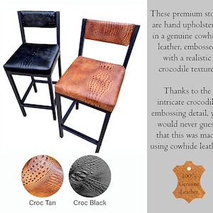 May include: Two bar stools with black metal frames. One stool has a black crocodile-embossed leather seat and back, the other has a tan crocodile-embossed leather seat and back. The stools are made of genuine cowhide leather.