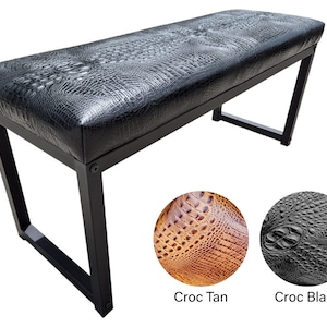 May include: Black bench with a crocodile-embossed leather seat and black metal legs. The bench is shown in two different colors: black and tan.