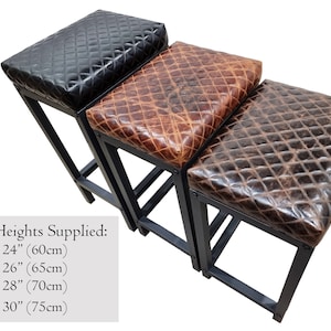 May include: Three bar stools with black metal frames and different colored leather seats. The seats are quilted and have a distressed look. The seat heights are 24 inches (60 cm), 26 inches (65 cm), 28 inches (70 cm), and 30 inches (75 cm).