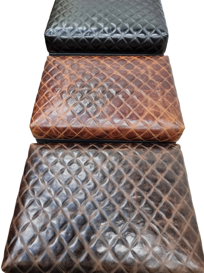 May include: Three quilted leather storage ottomans in black, brown, and dark brown.