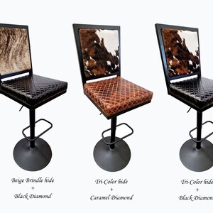 May include: Three bar stools with black metal frames and upholstered seats. The seats are covered in a variety of cowhide patterns, including beige brindle, tri-color, and caramel diamond.