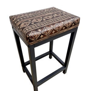 May include: A black metal bar stool with a brown and beige patterned upholstered seat.