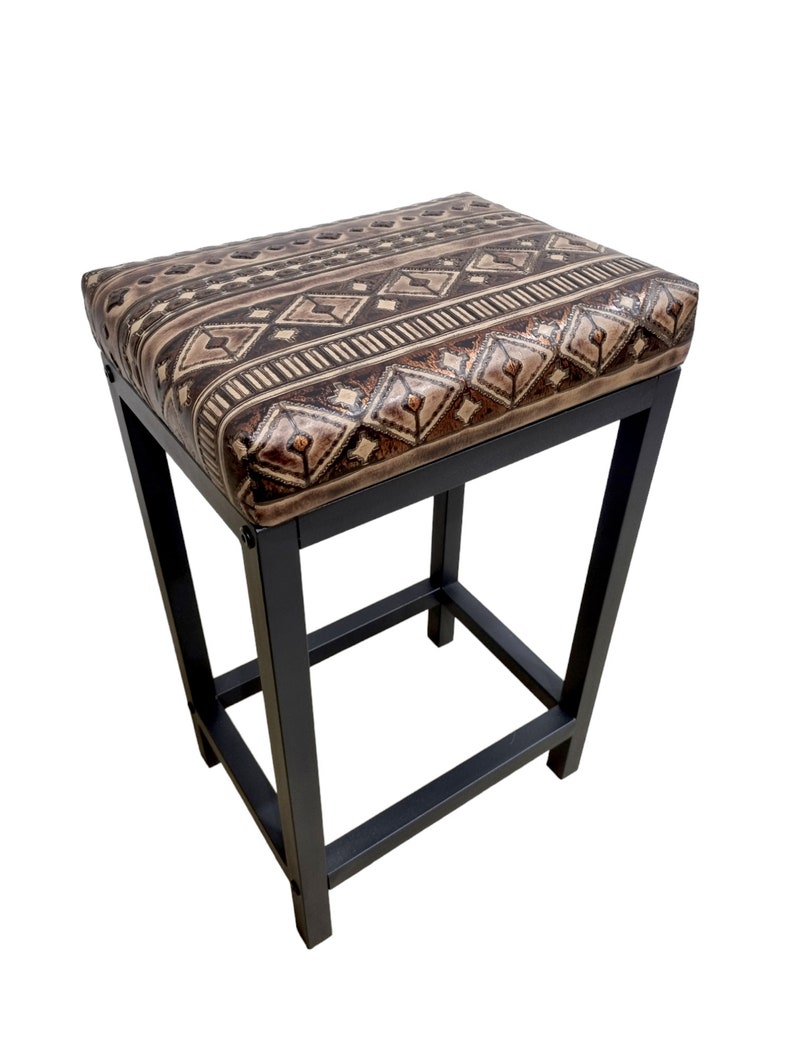 May include: A black metal bar stool with a brown and beige patterned upholstered seat.