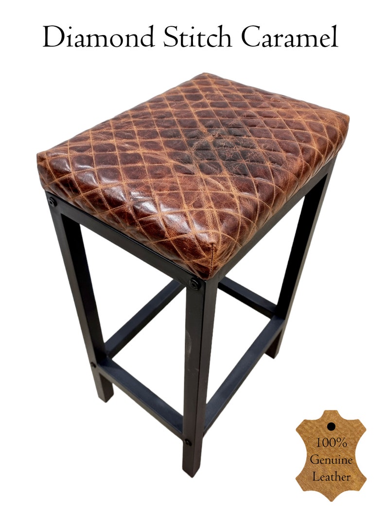 May include: A brown leather bar stool with a diamond stitch pattern. The stool has a black metal frame and a 100% genuine leather seat. The stool is perfect for adding a touch of rustic charm to any bar or kitchen.
